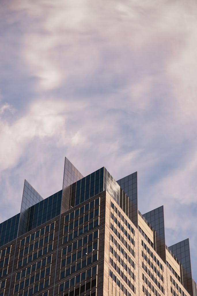 A striking modern skyscraper with a unique design against a dramatic sky.